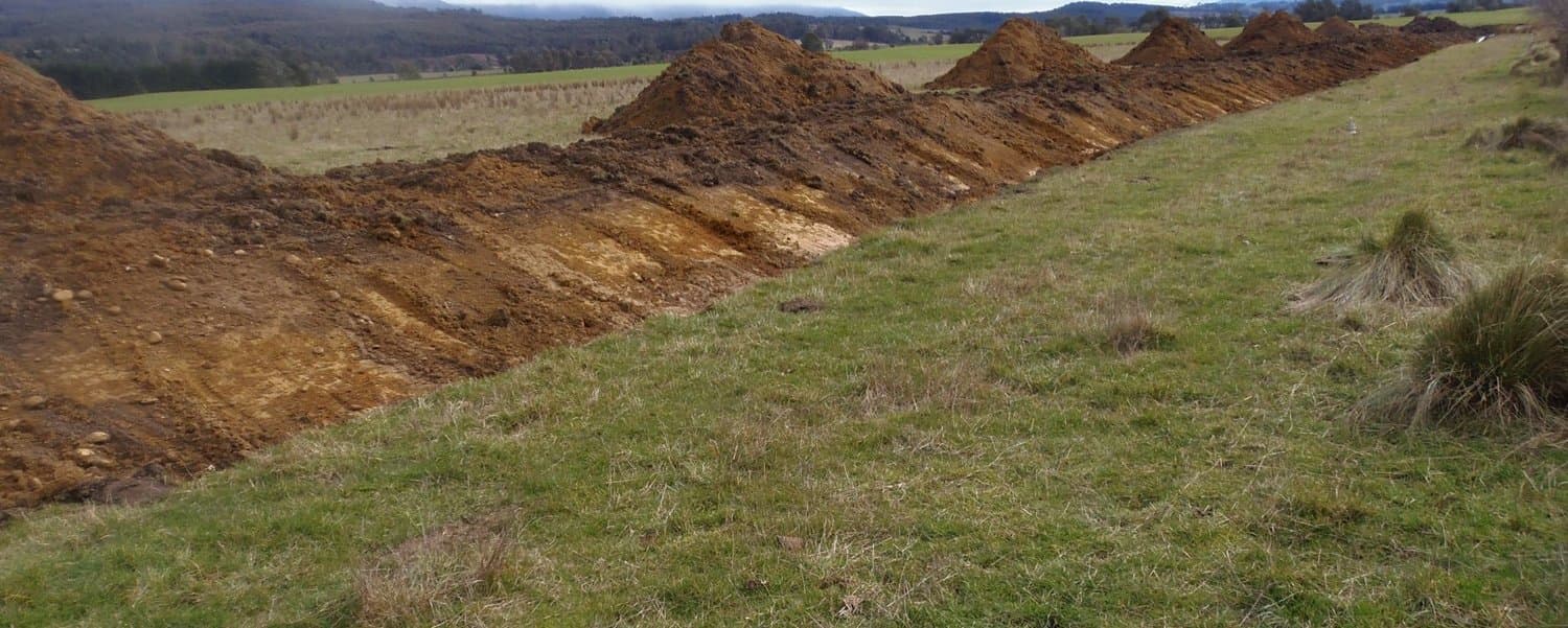 Figure 39. Leave gaps in spoil piles to allow surface water to flow to the drain.