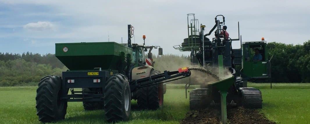 Figure 58. Hopper feeding backfill gravel to trenching drain laying machine. Photo by Will Wishaw.