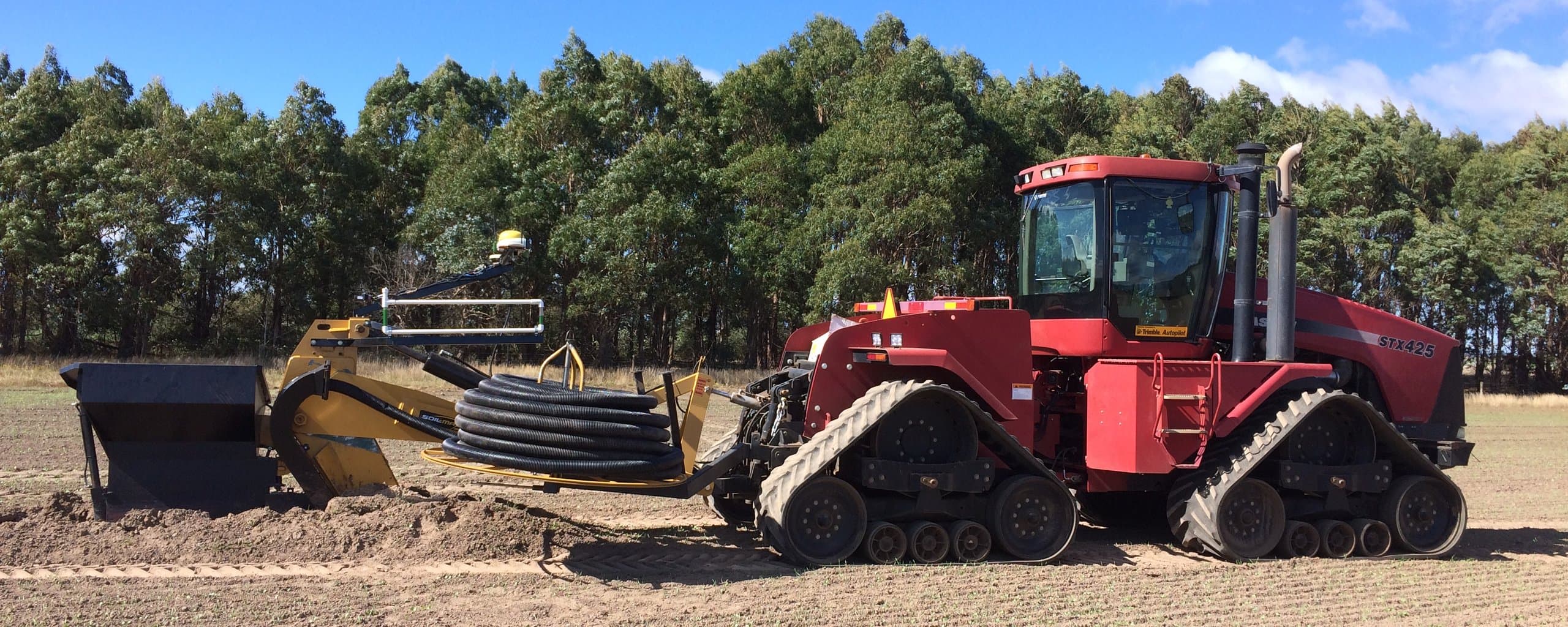 Figure 6. Drain plough installing underground drains on Mill Farm. Photo by Greg Gibson.